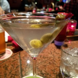 A martini with olives and olives in it.