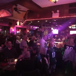 A crowd of people at a bar.