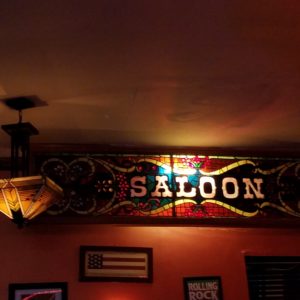 A bar with a sign that says saloon.