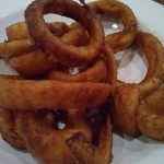 Fried onion rings on a plate.